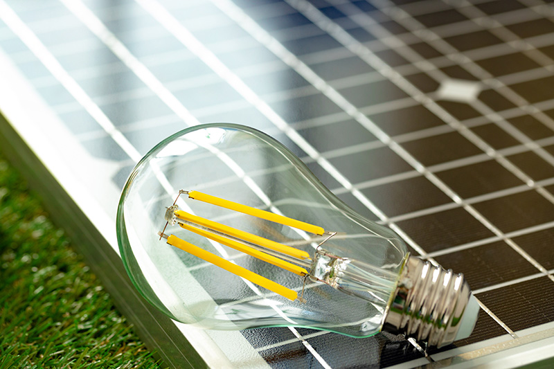 Solar energy panel and light bulb, green energy concept