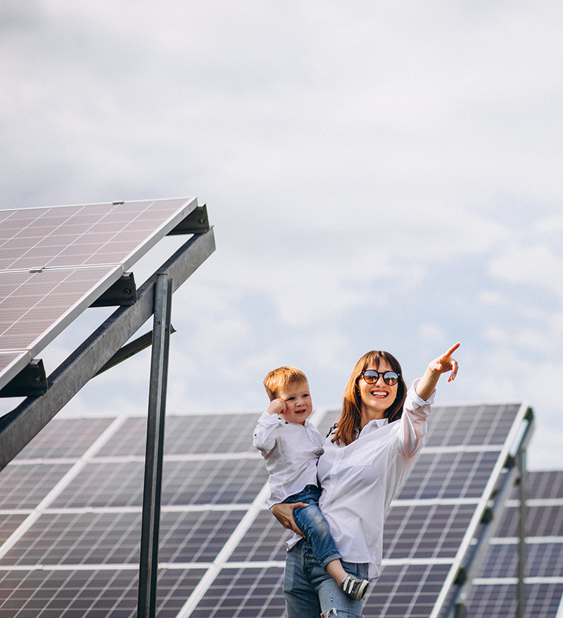 Mother with her little son by solar panels